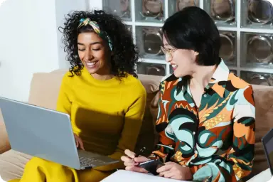 Two women looking at a laptop together