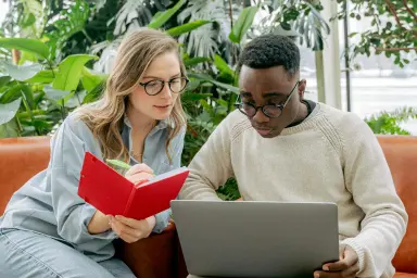 Woman and man looking at laptop together