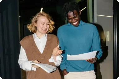 A man and woman reviewing a report while walking